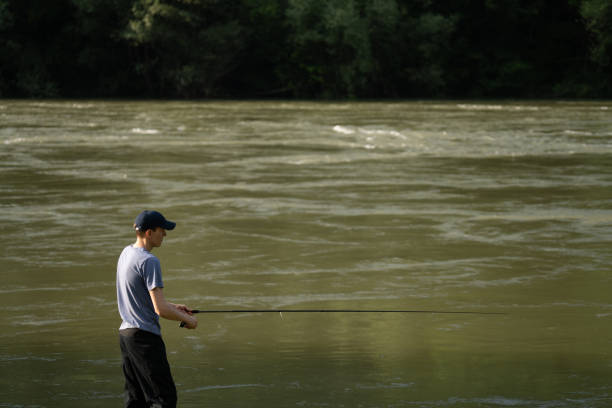 istock Man fishing on the mountain river 2114781281