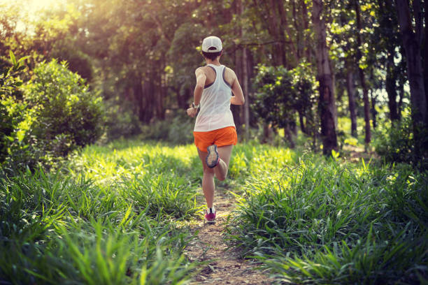 istock Trail runner running in summer forest trail 2114784654