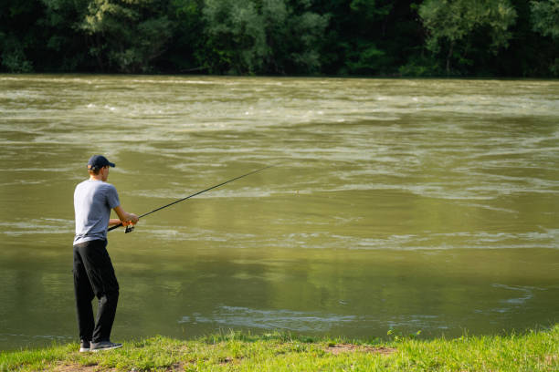 istock Man fishing on the mountain river 2114798130