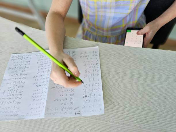 istock Student is cheating at the test exam with cheat answer written on smartphone concept 2114798396