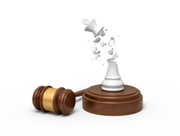 istock 3d rendering of broken white chess king, its crumbs in air, standing on sounding block with gavel beside. 2114810410
