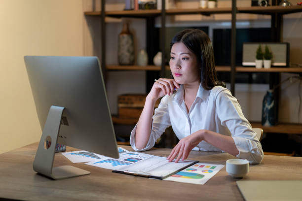 istock The young woman is working late into the night 2114821328