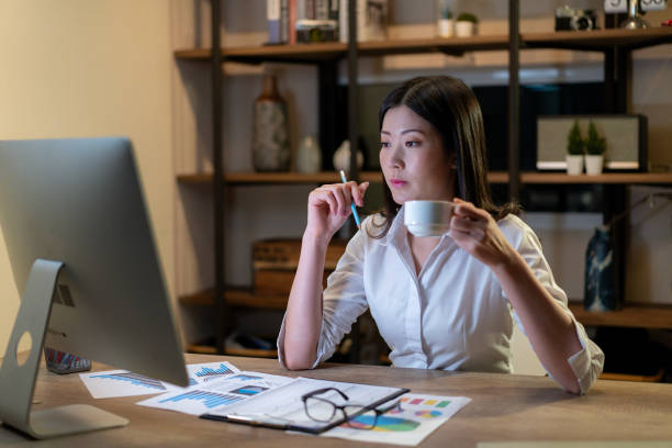 istock The young woman is working late into the night 2114821834