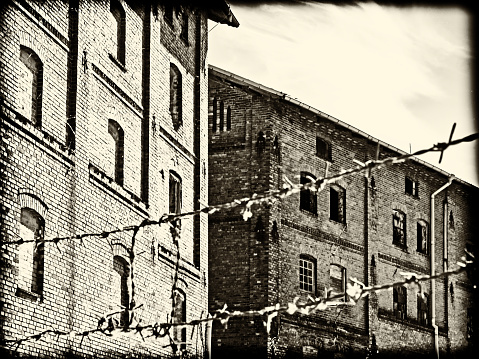 Sepia-toned image of an old factory with a vintage look.