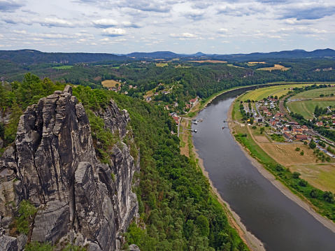 View from the Bastei rock formation to the village of Rathen and the Elbe in Saxon Switzerland, Germany.