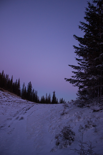 Winter mountain landscape with long angle view during purple sunset
