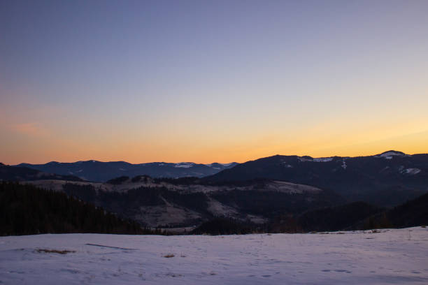 istock Scenic view of mountains against sky during yellow sunset 2114822923