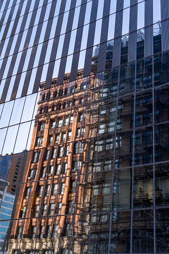 Wall Street buildings with reflections of other office buildings.