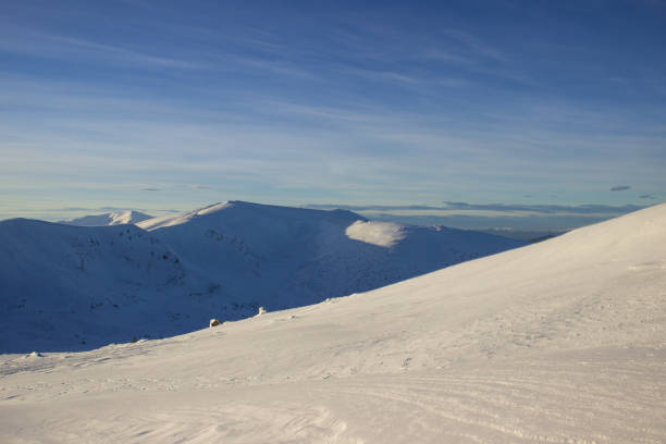 istock Snow covered land and blue sky 2114826121