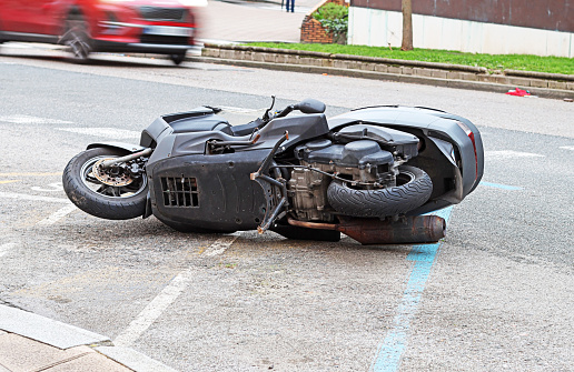 A motorbike lying on a street.