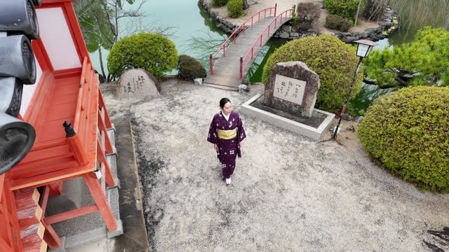 Woman in kimono walking in shrine - part 2 of 6