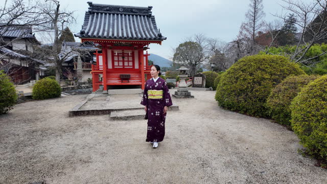 Woman in kimono walking in shrine - part 4 of 6