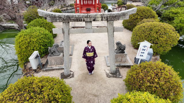 Woman in kimono walking in shrine - part 5 of 6