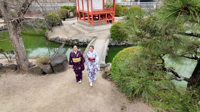 Female friends in kimono walking in shrine - part 2 of 2