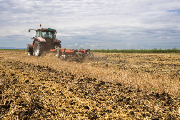 istock Tractor preparing land with seedbed cultivator. 2114858253