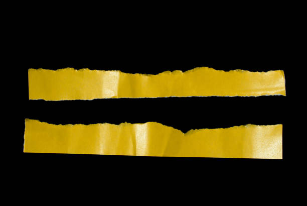 istock Yellow ripped paper isolated on black background 2114871998