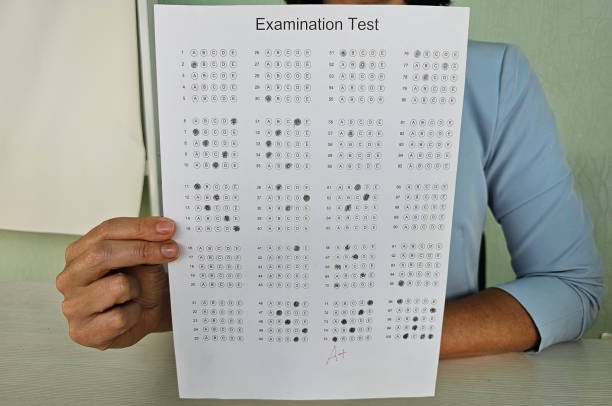 istock Hand with pen on examination test paper with excellent mark closeup 2114879828
