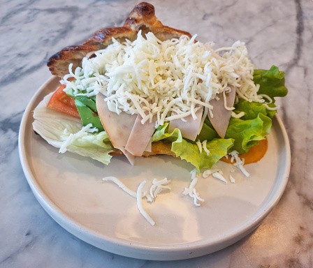 Fresh pastry Croissant with cheese and salad