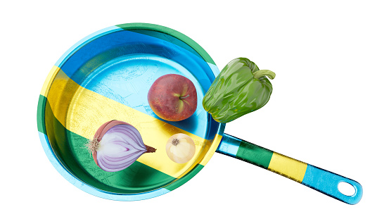 A colorful depiction of a frying pan designed with the Gabonese flag theme, tastefully paired with healthy vegetables.