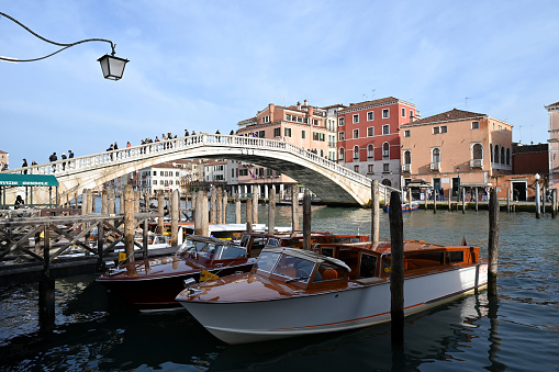 Venice, Italy, march 11, 2024 : Taxi boats on the Grand Canal with the Degli Scalzi bridge in the background