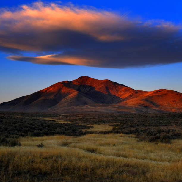 istock Sunset or Sunrise on Mountain with Cloud in Sky 2114907967
