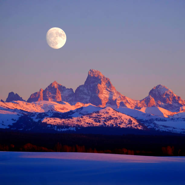 istock Sunset Light Alpen Glow on Tetons Teton Mountains wtih Moon Rising 2114907969