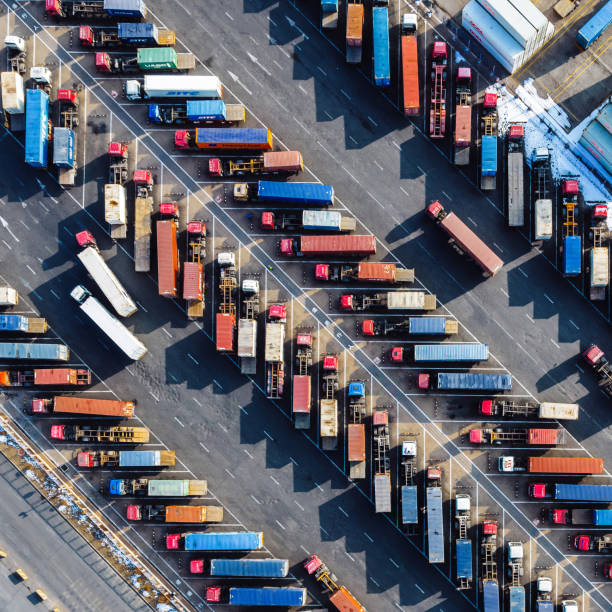 istock Aerial View, Rows of Trucks Driving in Harbor with Trailers 2114910571