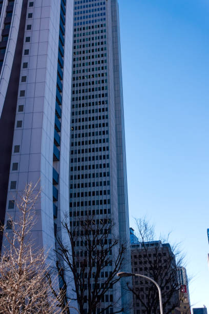Looking up skyline with modern skyscrapers and Sompo Japan Head Office Building at Japanese City of Tokyo on a sunny winter day. Photo taken January 27th, 2024, Tokyo, Japan.