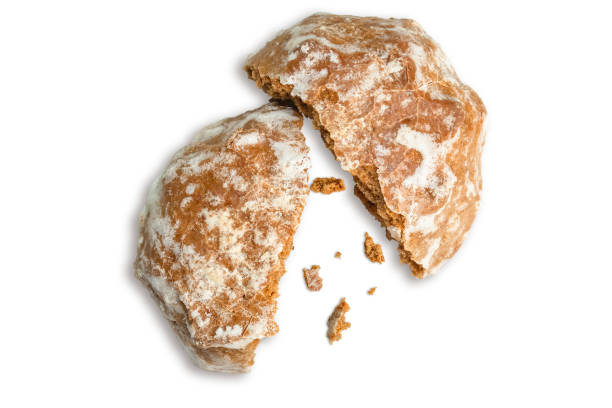 istock Gingerbread is broken in half with crumbs scattered. 2114915448