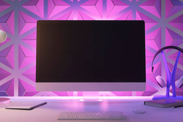 istock A modern desktop setup with a computer monitor, keyboard, headphones, and a notebook, with a geometric purple background. 3D Rendering 2114918666