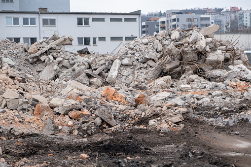 Piles of rubble from demolished house walls. Construction ruined destroyed debris. Concept of old house demolition and new construction