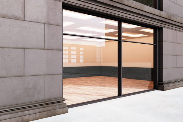istock An empty storefront with a large window display, modern design, on a building facade, set in a light outdoor urban environment. 3D Rendering 2114952308