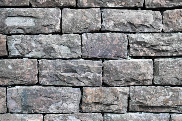 istock A wall made of large gray blocks. 2114976388