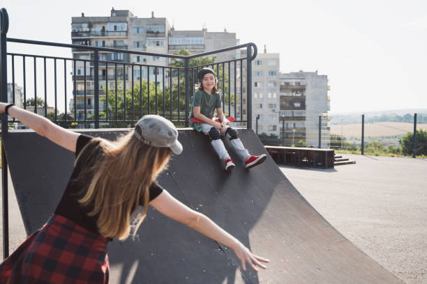 istock Mother and son having skateboarding training in skateboard park 2114979071