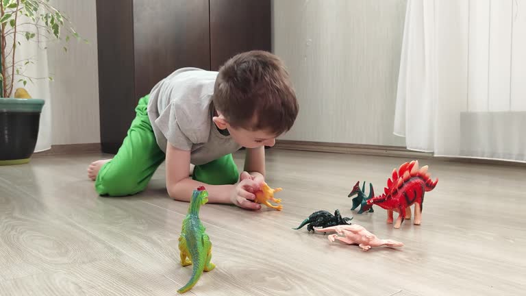 child happily plays with new toys in a large bright room at home. shopping for children