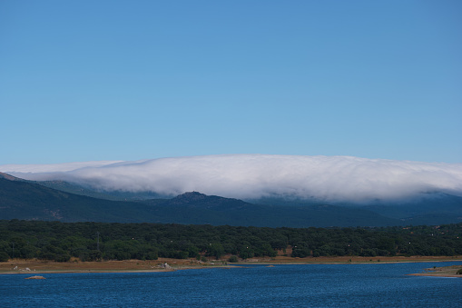landscape view of lake valmayor near madrid in the background the sierra de guadarrama mountains