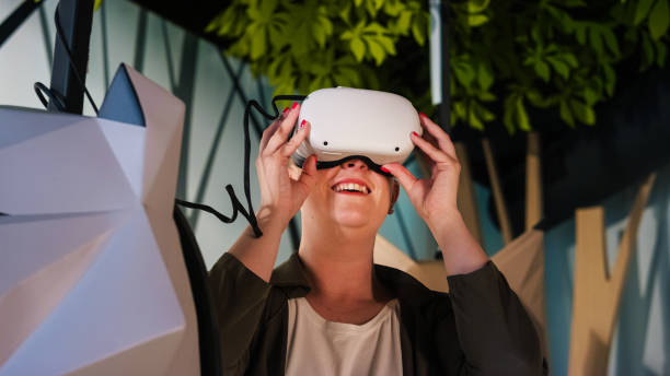 istock Woman with a virtual reality headset having fun in a museum VR room 2115065445