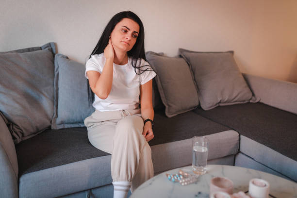 istock Young woman having neckache while being at home 2115071803