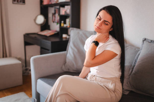 istock Young woman having neckache while being at home 2115072307