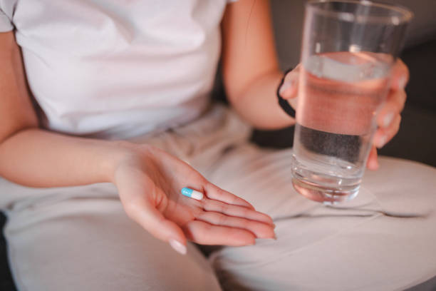istock Close-up of a woman's hands holding a pill 2115072322