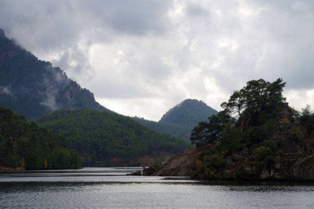 istock fog and low clouds over the mountain lake Dospat Bulgaria 2115107799