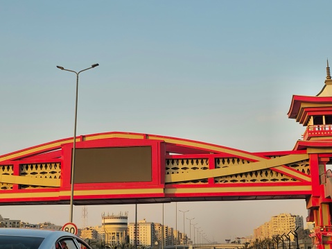Cairo, Egypt, March 23 2024: Shinzo Abe axis patrol highway in Egypt with a pedestrian bridge finished in traditional Japanese architectural style, the traffic highway is named on former Japanese PM, selective focus
