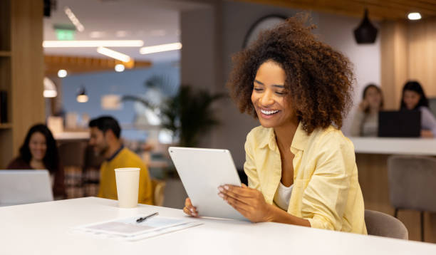 istock Happy businesswoman working at a coworking office using a digital tablet 2115126822