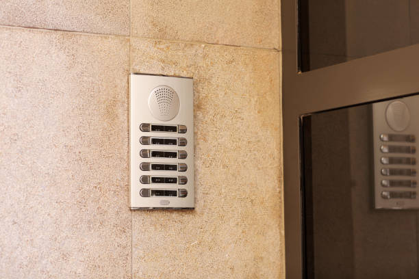 istock Outdoor intercom outside a residential building with empty name tag cards. Silver modern doorbells with blank nameplates suitable for adding text. European intercom communication system 2115153482
