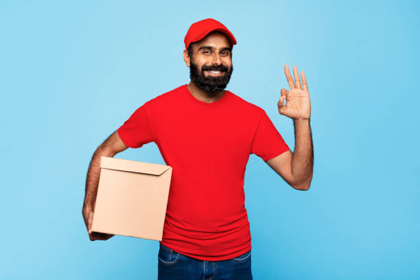 istock Delivery indian man with box giving okay sign 2115159753
