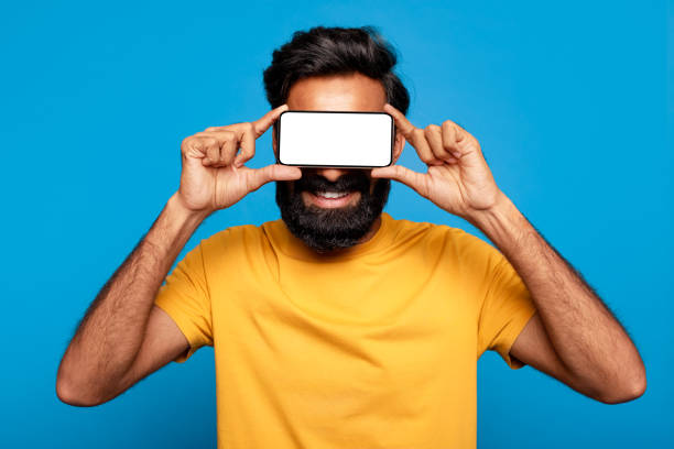 istock Happy man using phone as pretend glasses 2115159785