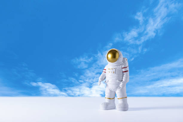 istock Figurine of astronaut over blue sky background, copy space. 2115183383