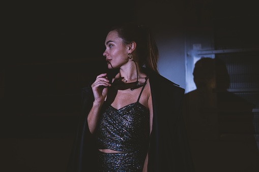 Fashion photo of well dressed young woman with spotlight.