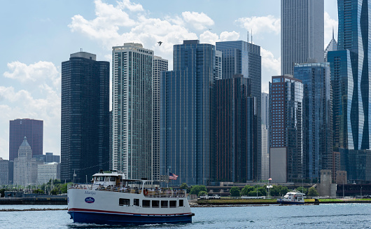 People on the tourboat Marilyn approach Navy Pier with beautiful Chicago skyline in the background.