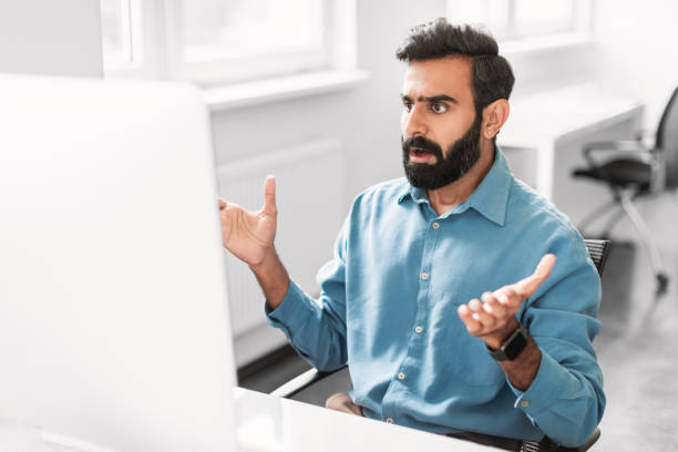 istock Surprised indian male office worker reacting to computer screen 2115226173